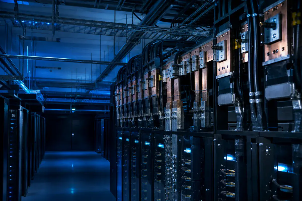 Busbar, power distribution and heavy cabling feeding a row of data centre racks