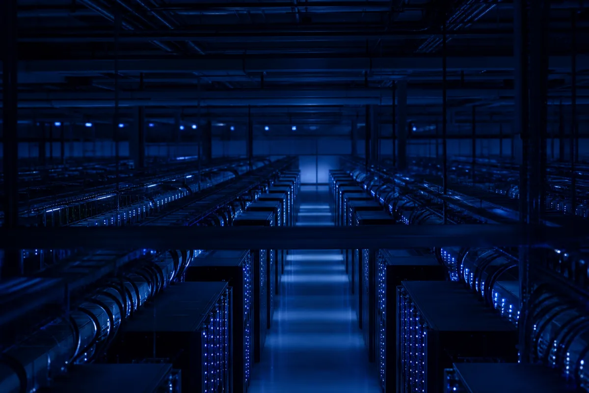 A vast AI training hall with long parallel rows of GPU racks